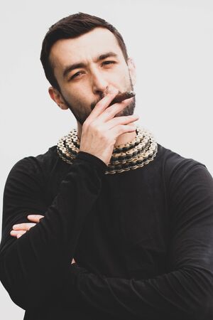 Handsome stylish man smokes a cigar.の写真素材