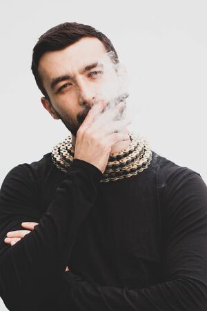 Handsome stylish man smokes a cigar.の写真素材