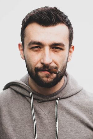 Handsome stylish man smokes a cigar.の写真素材