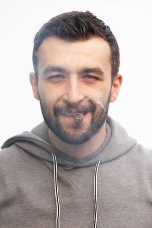 Handsome stylish man smokes a cigar.の写真素材