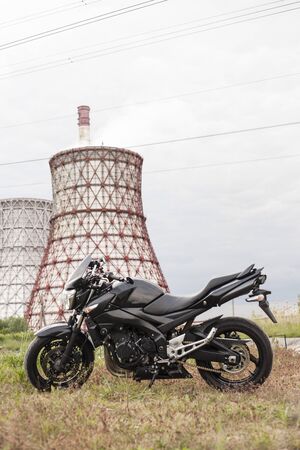 Sports black motorcycle near the power plant.の写真素材