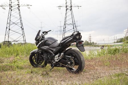 Sports black motorcycle near the power plant.の写真素材