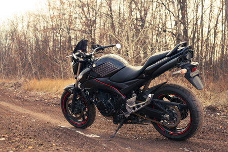 UKRAINE, KIEV - NOVEMBER 22, 2020: Powerful black motorcycle Suzuki GSR600 in forest autumn.のeditorial素材