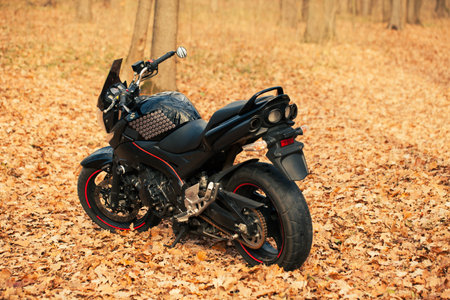 UKRAINE, KIEV - NOVEMBER 22, 2020: Powerful black motorcycle Suzuki GSR600 in forest autumn.のeditorial素材