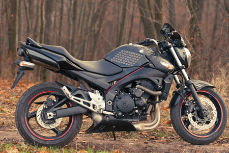 UKRAINE, KIEV - NOVEMBER 22, 2020: Powerful black motorcycle Suzuki GSR600 in forest autumn.