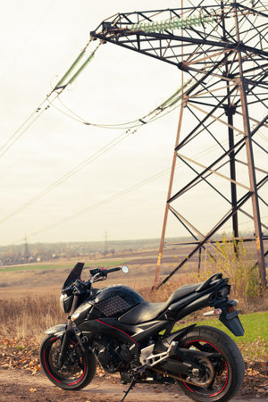 Black stylish sport motorcycle in autumn forest.のeditorial素材