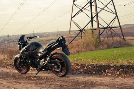 Black stylish sport motorcycle in autumn forest.のeditorial素材
