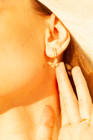 Beautiful gold jewelry on a girl close-up.の写真素材
