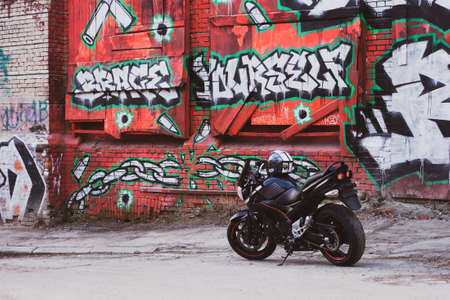 UKRAINE, KIEV - JULY 10, 2021: Suzuki GSR600 sport black motorcycle on graffiti background.のeditorial素材