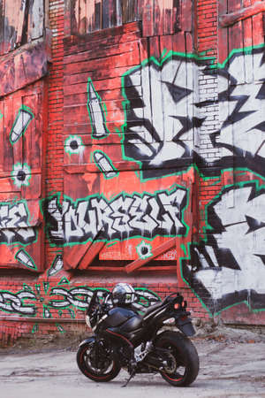 UKRAINE, KIEV - JULY 10, 2021: Suzuki GSR600 sport black motorcycle on graffiti background.のeditorial素材