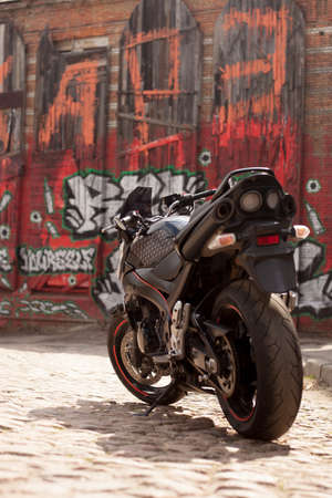UKRAINE, KIEV - JULY 10, 2021: Suzuki GSR600 sport black motorcycle on graffiti background.のeditorial素材