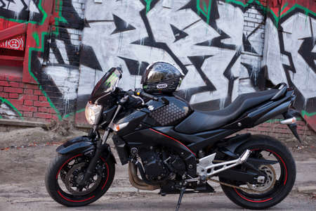UKRAINE, KIEV - JULY 10, 2021: Suzuki GSR600 sport black motorcycle on graffiti background.のeditorial素材