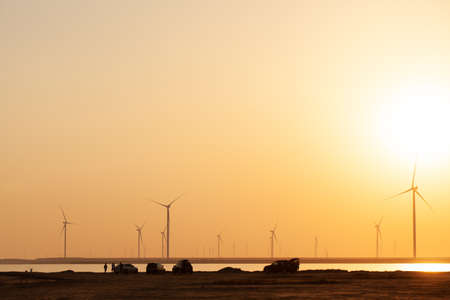 Modern electric mills and the sea.の写真素材