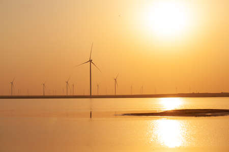 Modern electric mills and the sea.の写真素材
