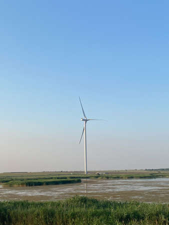 Modern electric mills and the sea.の写真素材