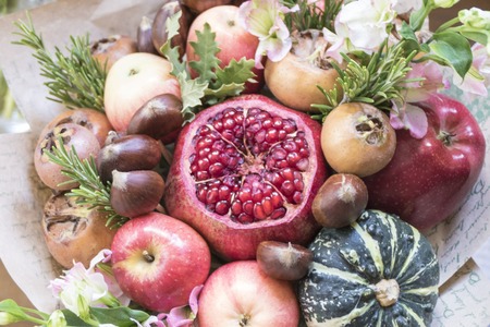 Bouquet of fresh fruits and vegetables wrapped in coarse paper closeupの写真素材