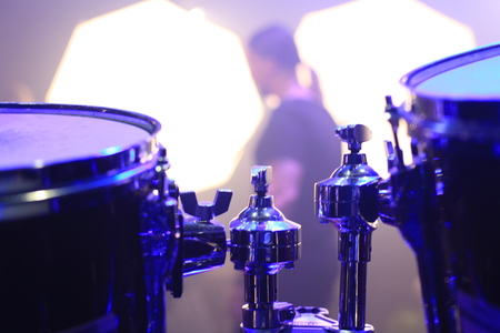 Empty stage before a rock concert from behind, drums in the foregroundの写真素材