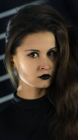 Beautiful femme fatale with bright makeup and black lipstick. Luxurious glamor portrait high fashion beauty model. Vogue Style Portrait on black backgroundの写真素材