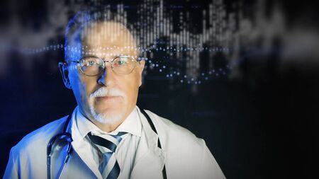 Mature doctor in white medical lab coat on dark background. Medium shot portrait elderly scientist in high tech laboratory. Handsome gray haired old doctor looking at augmented reality screen.の写真素材