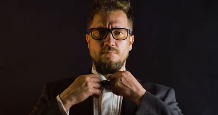 Handsome man in suit on black background. Portrait of elegance gentleman with glasses. Luxury lifestyle. Portrait of adult spy wearing trendy suit in studio.の写真素材