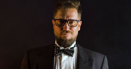 Handsome man in suit on black background. Portrait of elegance gentleman with glasses. Luxury lifestyle. Portrait of adult spy wearing trendy suit in studio.の写真素材