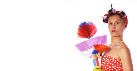 Retro woman in a red dress and a yellow household gloves with a cleaning accessory. Isolated on white background. Housework or cleaning concept.の写真素材