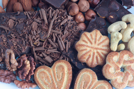 Chocolate,cookies and nuts lying on the dinner table. Close-up.の写真素材