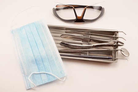 Group of dental tools in medical tray. Isolated on white background.の写真素材