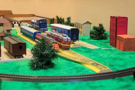 Toy railway with various buildings. Older and modern transport.の写真素材