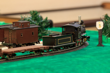 The old steam locomotive carries the freight train. Toy railroad. Carefree childhood.の写真素材