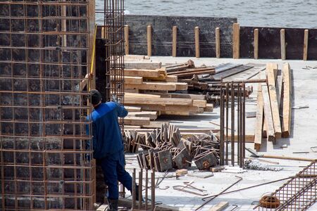 Construction workers working on cement formwork frames. Construction of a new building.