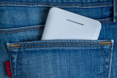 Mobile phone in rear jeans pocket. Modern lifestyle.の写真素材