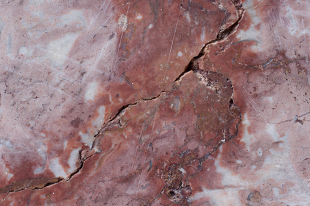 Reddish-brown base with dark and gray spots. Classic travertine texture. Used as a background.の写真素材