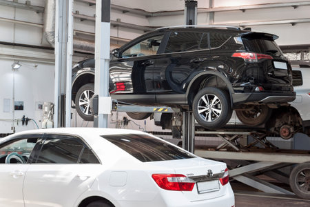Russia, Izhevsk - April 21, 2018: Automobile workshop. Car repair in the workshop on the hydraulic lift.のeditorial素材