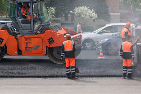 Russia, Izhevsk - May 30, 2018: Road work. Laying new asphalt on top of the old.のeditorial素材