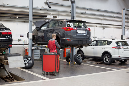 Russia, Izhevsk - April 21, 2018: Service center Toyota. Replacement and wheel alignment on a hydraulic lift. Modern service.のeditorial素材