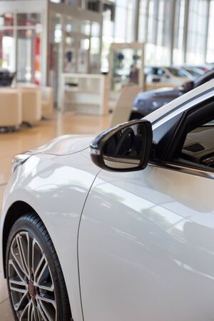 New cars at dealer showroom. Car auto dealership. Prestigious vehicles.