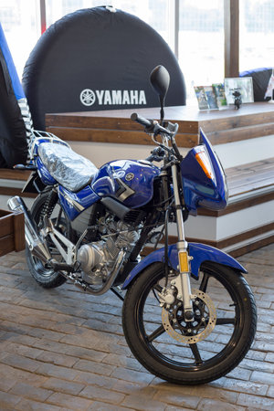 Russia, Izhevsk - August 23, 2019: Yamaha motorcycle shop. New motorbike YBR125 in modern motorcycle store. Famous world brand.のeditorial素材
