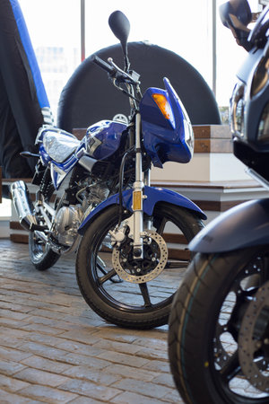 Russia, Izhevsk - August 23, 2019: Yamaha motorcycle shop. New motorbike YBR125 in modern motorcycle store. Famous world brand.のeditorial素材