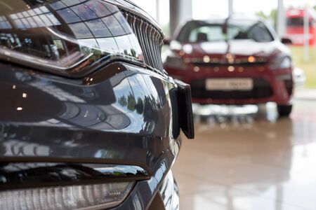 New cars at dealer showroom. Themed blur background with bokeh effect. Car auto dealership....