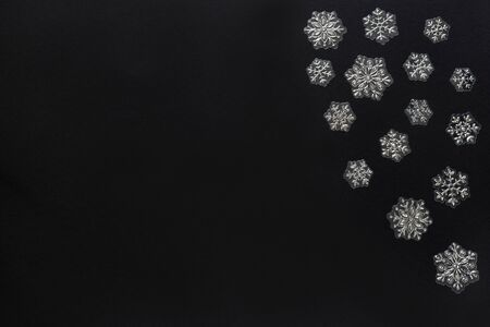 Fairytale decorative snowflakes isolated on black background. Concept of Christmas and new year. Copy space for your text. Flat lay.の写真素材