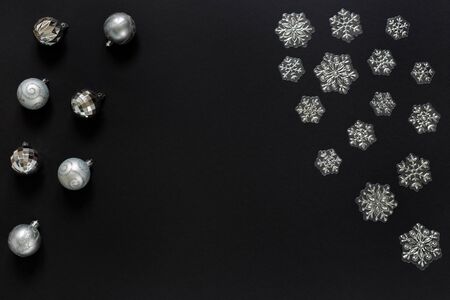 Christmas balls and decorative snowflakes isolated on black background. Concept of Christmas and new...
