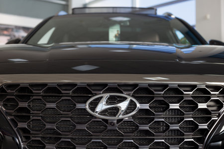 Russia, Izhevsk - January 23, 2020: Hyundai logo on a new car at a dealership showroom. Famous world...