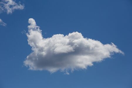 Snow-white air cloud on a background of blue sky. Planet earth.