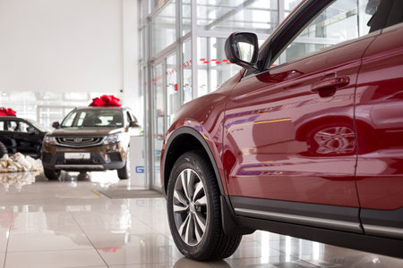 Russia, Izhevsk - August 14, 2020: New modern cars in the Geely showroom. Front and side view. Car manufacturer from China.のeditorial素材