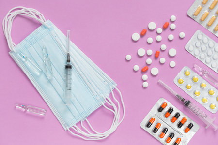 Medical face masks, packaging with pills, ampullas and expendable syringes for vaccination. Coronavirus vaccination concept and other infection diseases.の写真素材