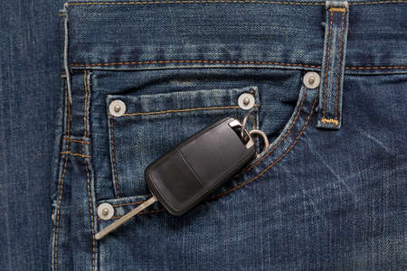 Ignition key is lying in side pocket of blue jeans. Modern lifestyle.の写真素材
