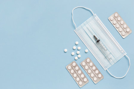 Medical face mask, packaging with pills, expendable syringe for vaccination. Coronavirus vaccination...