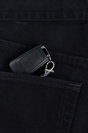 Switch key is lying in side pocket of black pants.