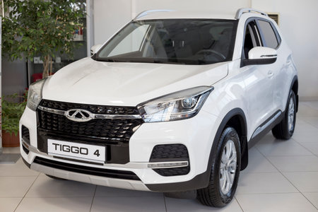 Russia, Izhevsk - August 19, 2021: Chery showroom. New modern Chery Tiggo 4 car in dealer showroom. Front view and side. Car manufacturer from China. Modern transportation.のeditorial素材